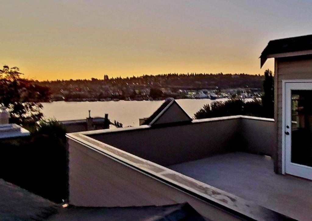a balcony with a view of a body of water at 4 Story Lakeside Home In Heart of Lake Union - Queen Anne Neighborhood in Seattle