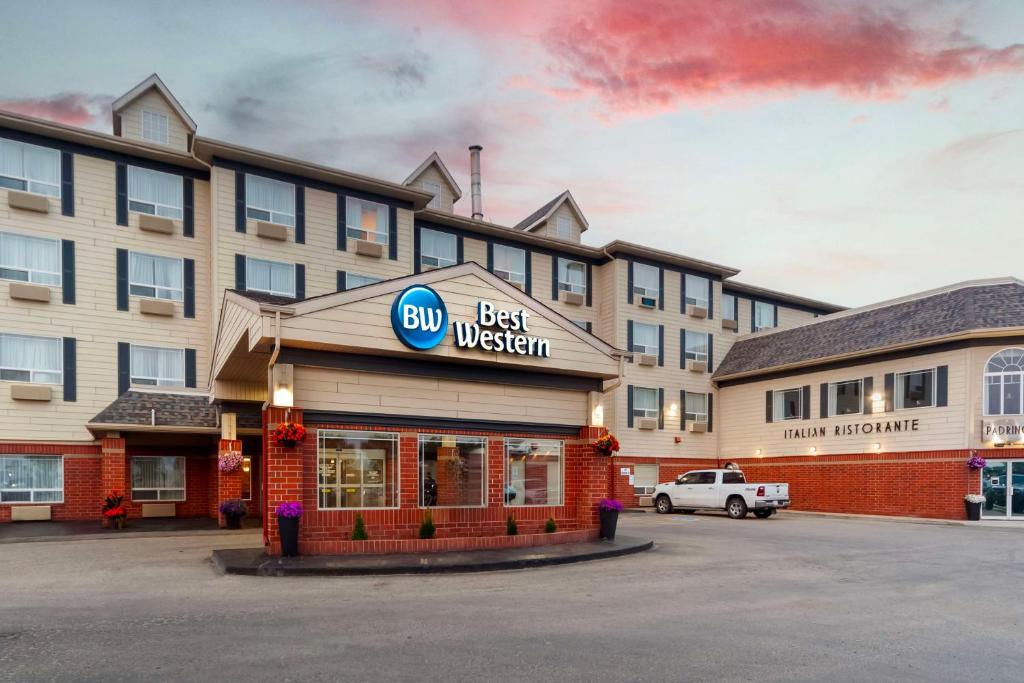 a building with a best western sign in a parking lot at Best Western Grande Prairie in Grande Prairie