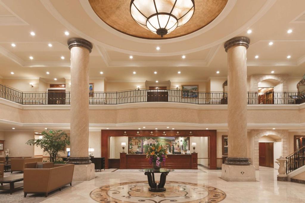 a lobby of a hotel with a large ceiling at Hilton Los Angeles/San Gabriel in San Gabriel