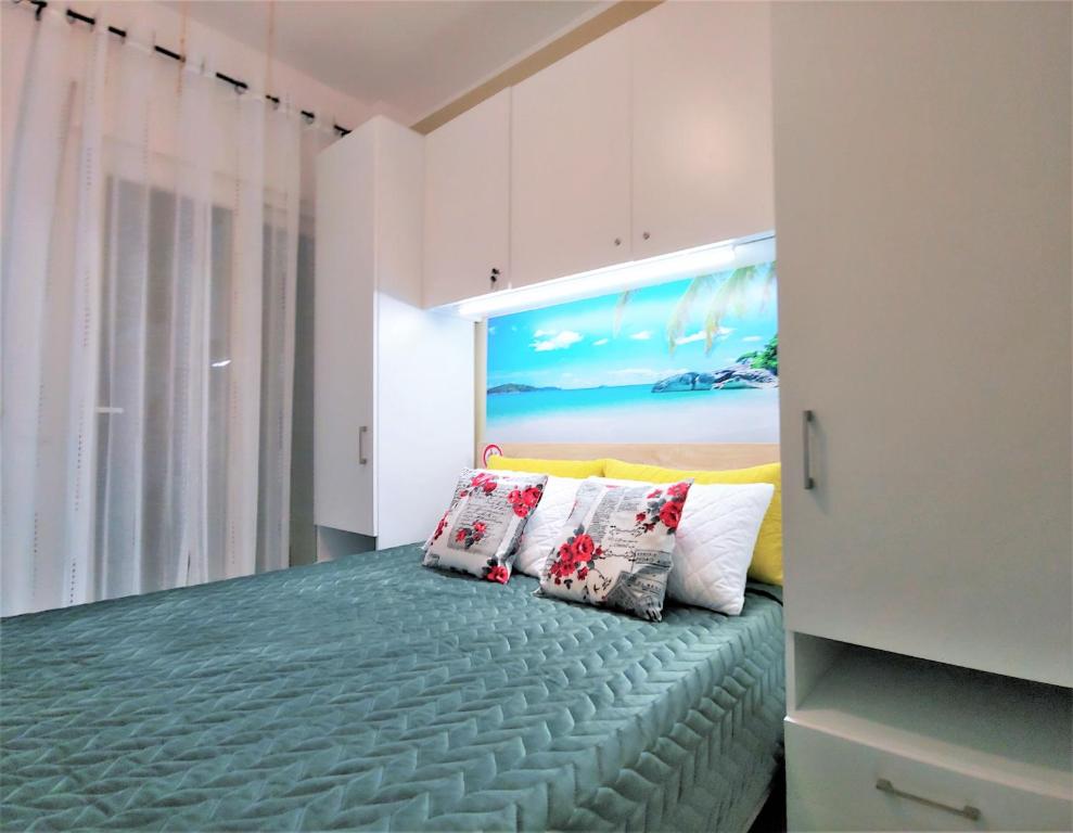 a bedroom with a bed with two pillows at Niko's Apartment - Beautiful Sea Apartment ! in Perea