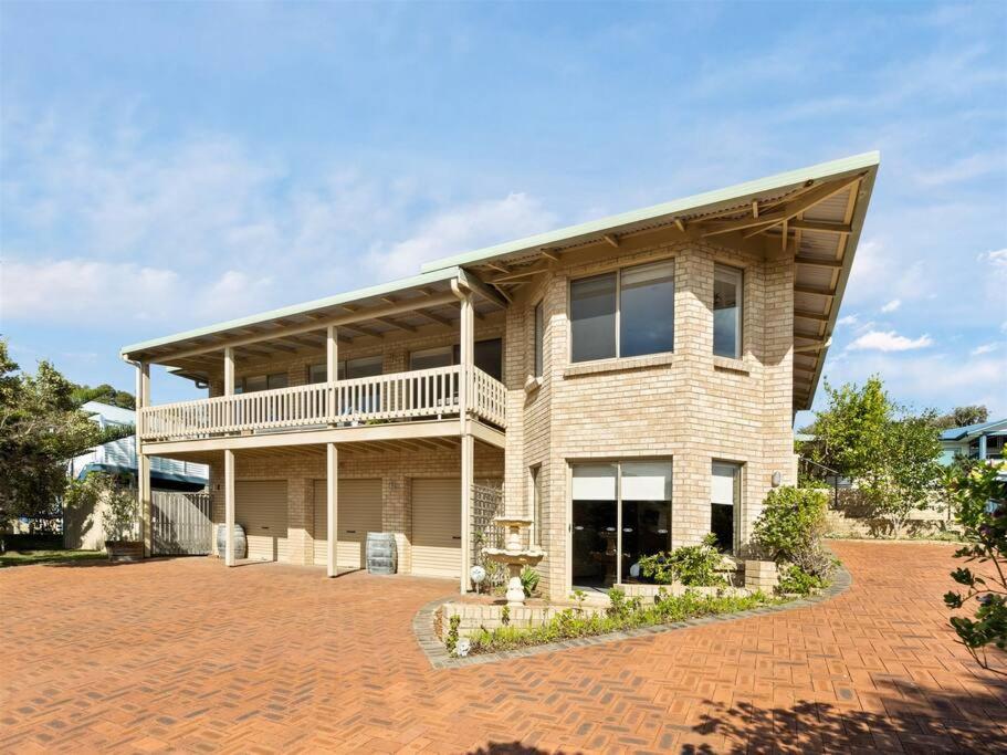 a large house with a balcony on a brick driveway at Whale Watch Augusta Family Retreat in Augusta