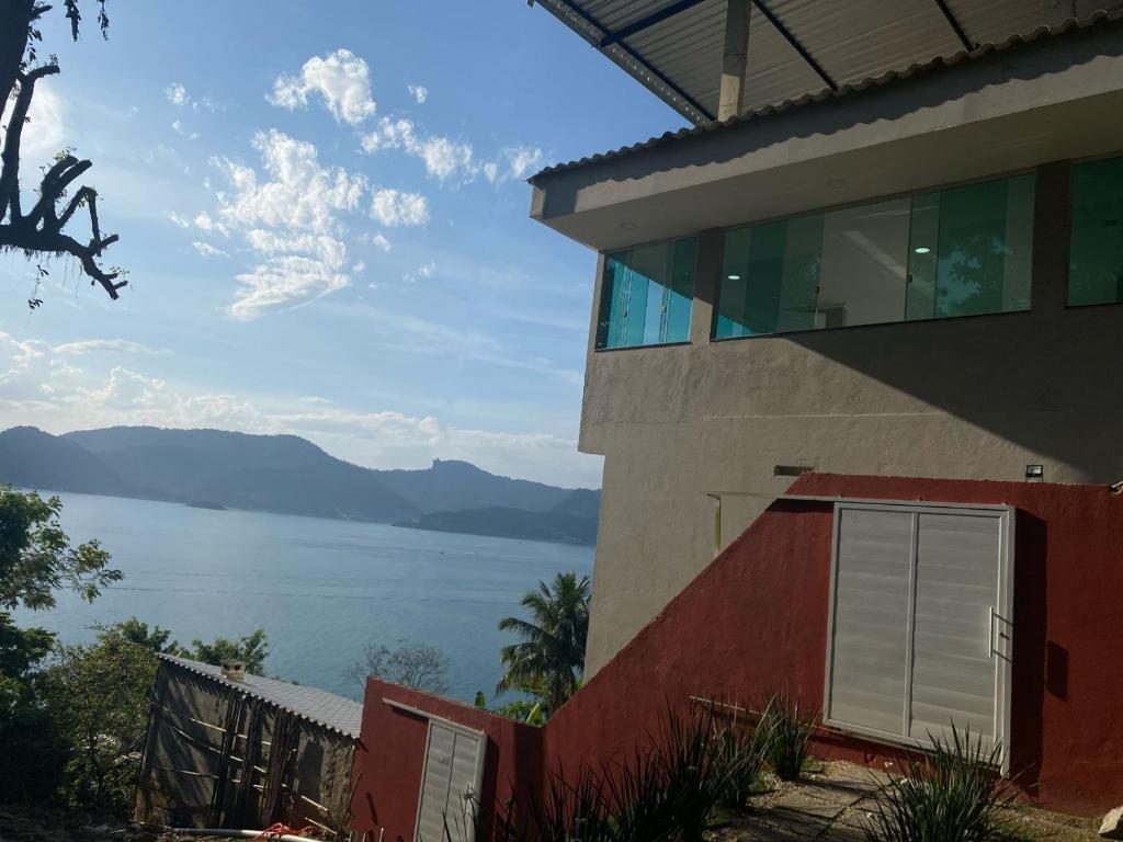 a building with a view of the water at Pousada Artelai in Angra dos Reis