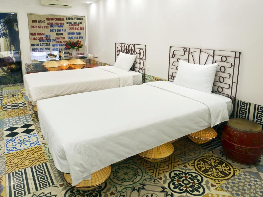 Postel nebo postele na pokoji v ubytování Thang Long Espana Hotel