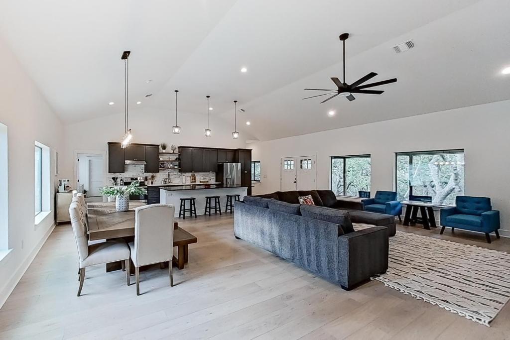 a living room and kitchen with a couch and a table at Stella Vista in Dripping Springs
