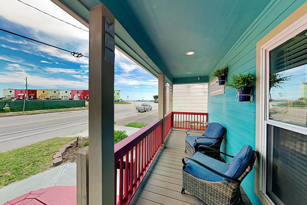 a porch with two chairs and a window at Serene Beachside Getaway - 77 Steps To The Ocean in Galveston