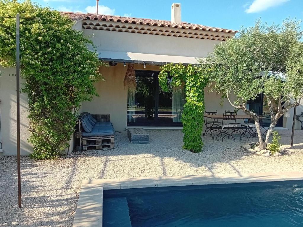 a house with a swimming pool in front of a house at Beautiful villa with private pool in the Luberon in Cucuron