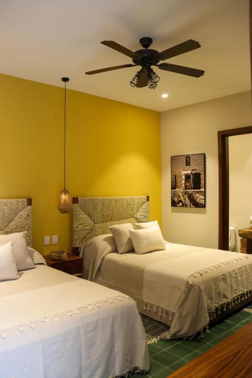 Postel nebo postele na pokoji v ubytování Hotel Boutique Gloriagave