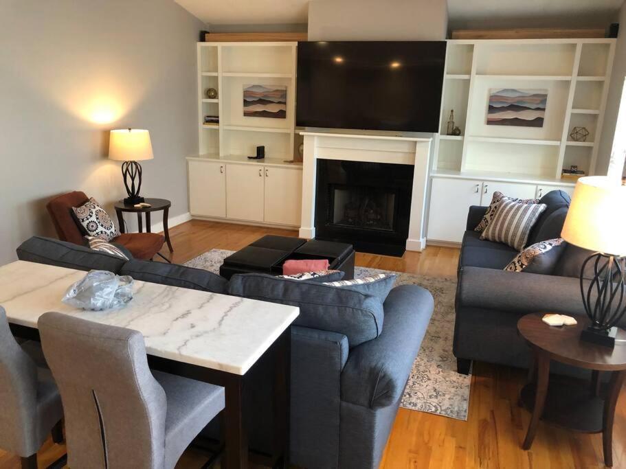 a living room with a couch and a fireplace at Medical Center NRG Retreat in Houston