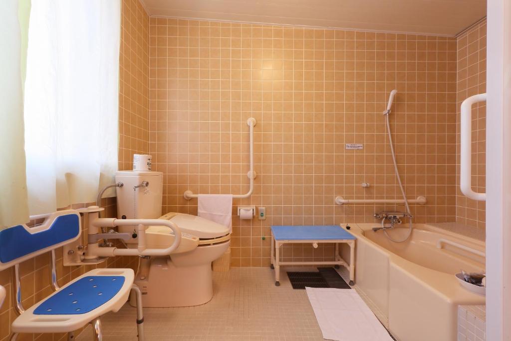 a bathroom with a toilet and a sink and a tub at Hotel Binario Saga Arashiyama in Kyoto