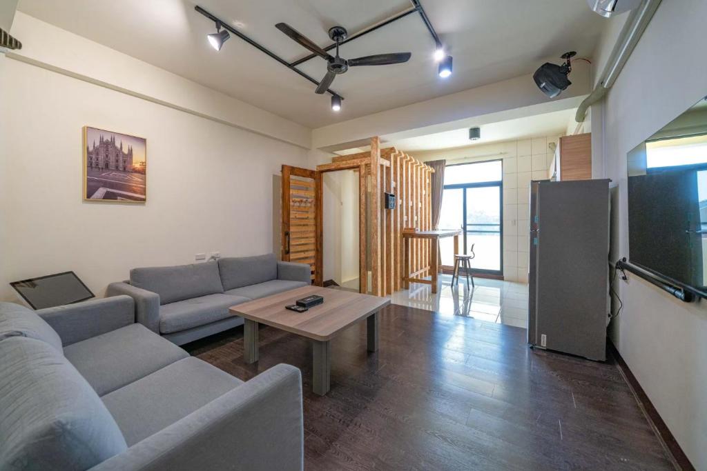 a living room with a couch and a table at 安平宜居包棟 ktv 民宿-依人數開放房型 in Tainan