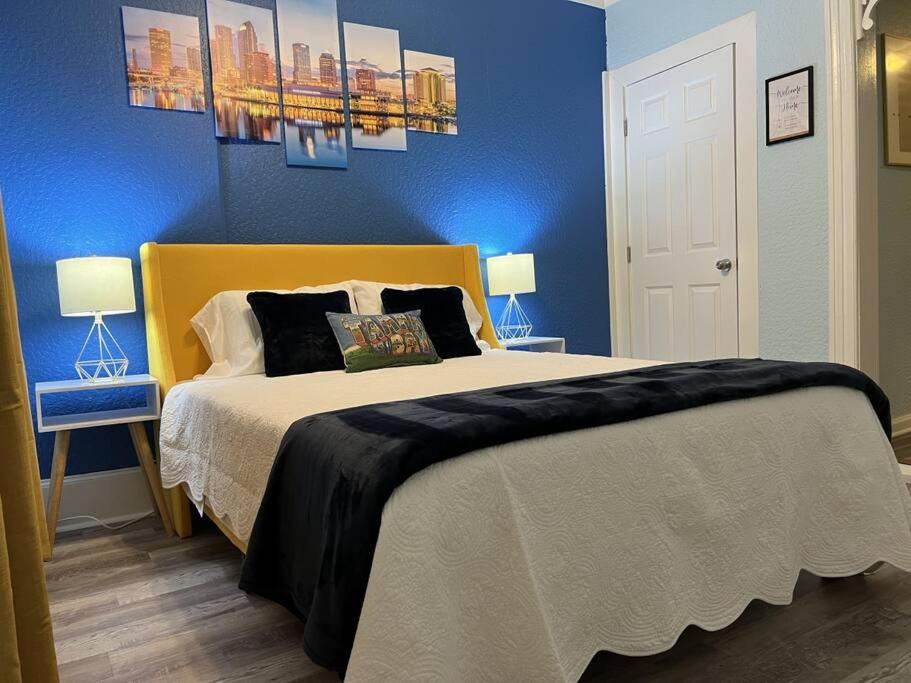 a bedroom with a large bed with blue walls at Luxury Suite by Tampa Convention Center & Hospital in Tampa