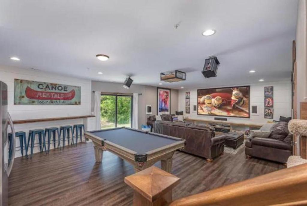 a living room with a pool table and a bar at ULTIMATE Getaway with Hot Tub, Theater, Pool Table in Hollister