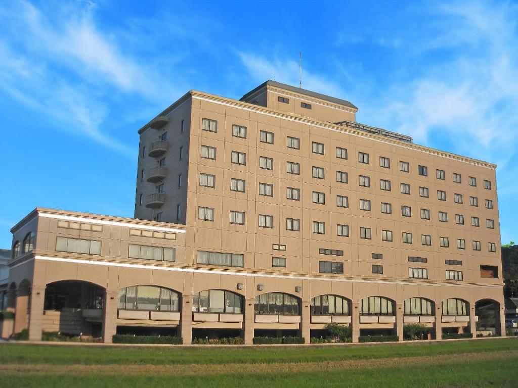 a large brick building with a blue sky in the background at サザンシティホテル in Nankoku