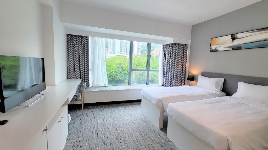 Ένα ή περισσότερα κρεβάτια σε δωμάτιο στο Grand Bay View Hotel