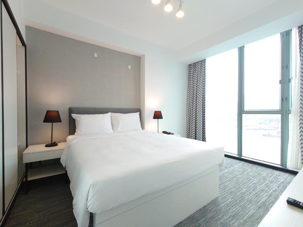 Ένα ή περισσότερα κρεβάτια σε δωμάτιο στο Grand Bay View Hotel