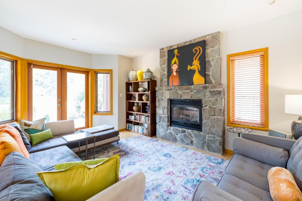 a living room with a couch and a fireplace at #8107 Muirfield Crescent in Whistler