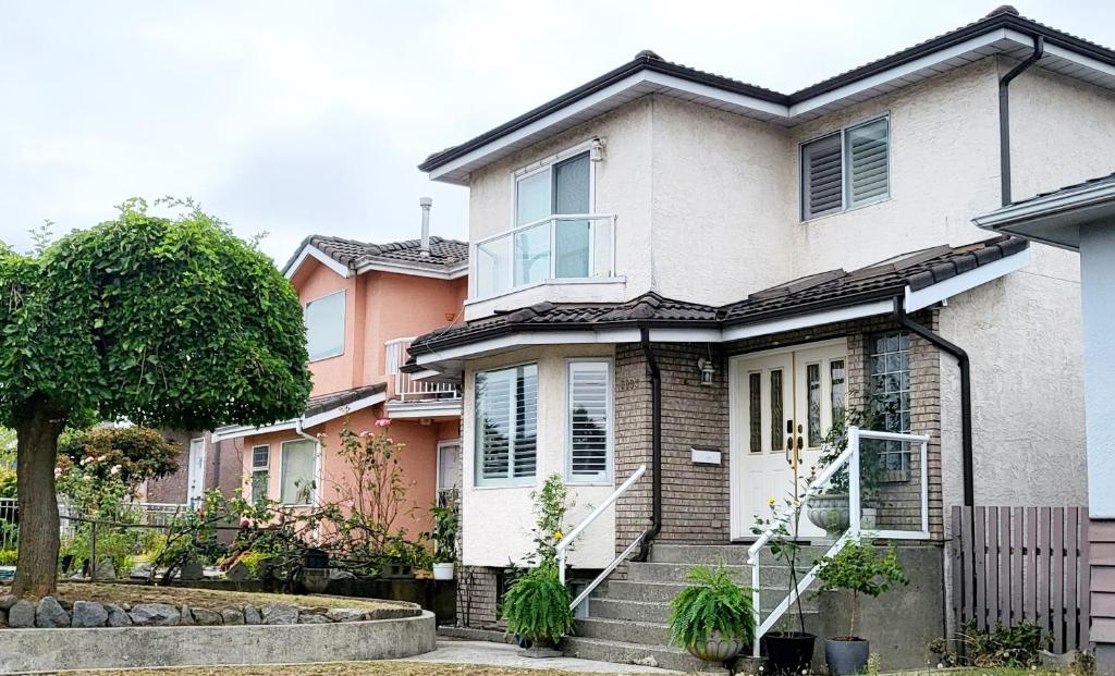 a house with stairs in front of it at Vivi's Home in Vancouver