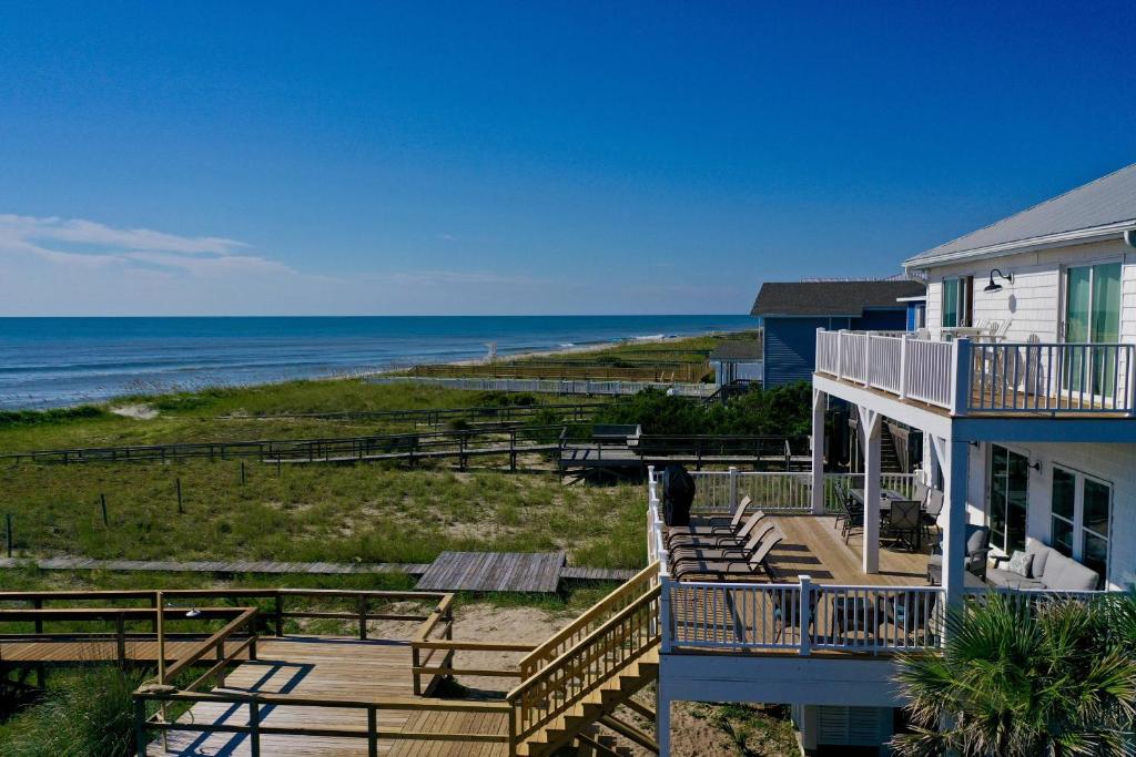 a house with stairs leading down to the beach at System Shutdown in Kure Beach