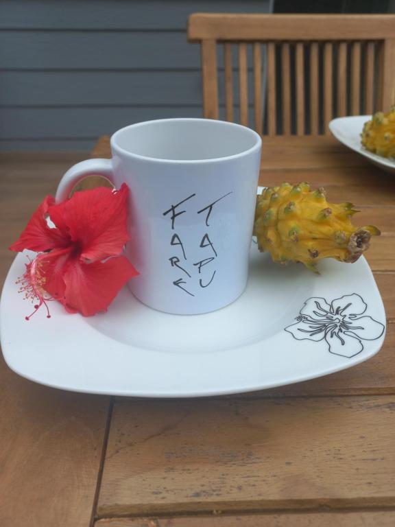 a coffee cup sitting on a plate on a table at Fare Tapu in Uturoa