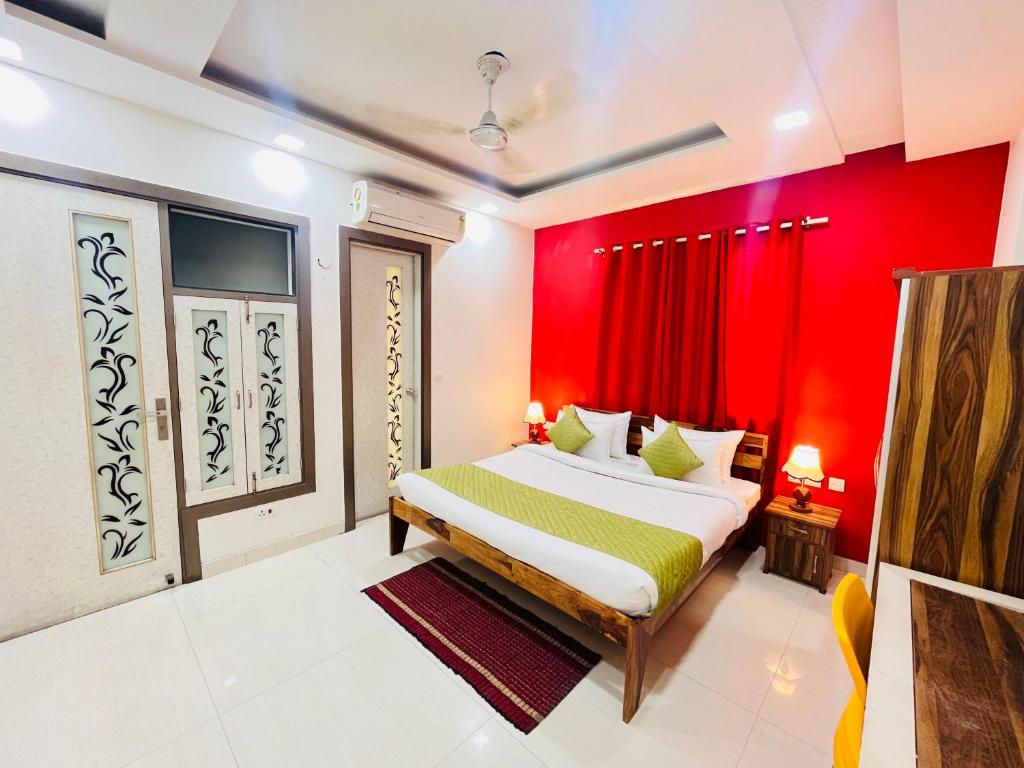 a bedroom with red walls and a bed in a room at Hotel Park Pride Pitampura New Delhi, Couple Friendly in New Delhi