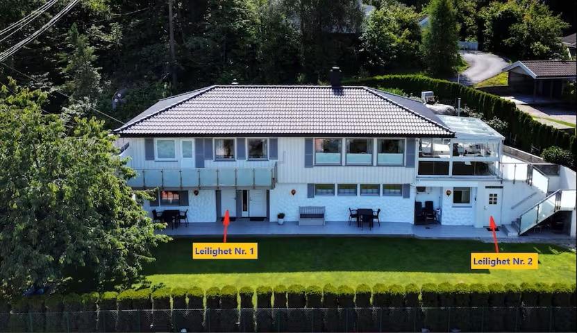 an aerial view of a white house with evacuation signs on it at Leilighet 1 og 2 - Mandal, Norges sørligste kommune in Ime