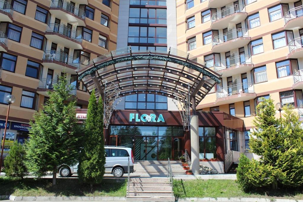 a white van parked in front of a building at PM Services Flora Apartments in Borovets