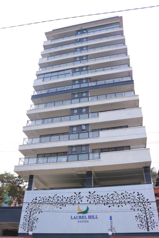a tall white building with a sign in front of it at CitiHeart Suite in Nairobi