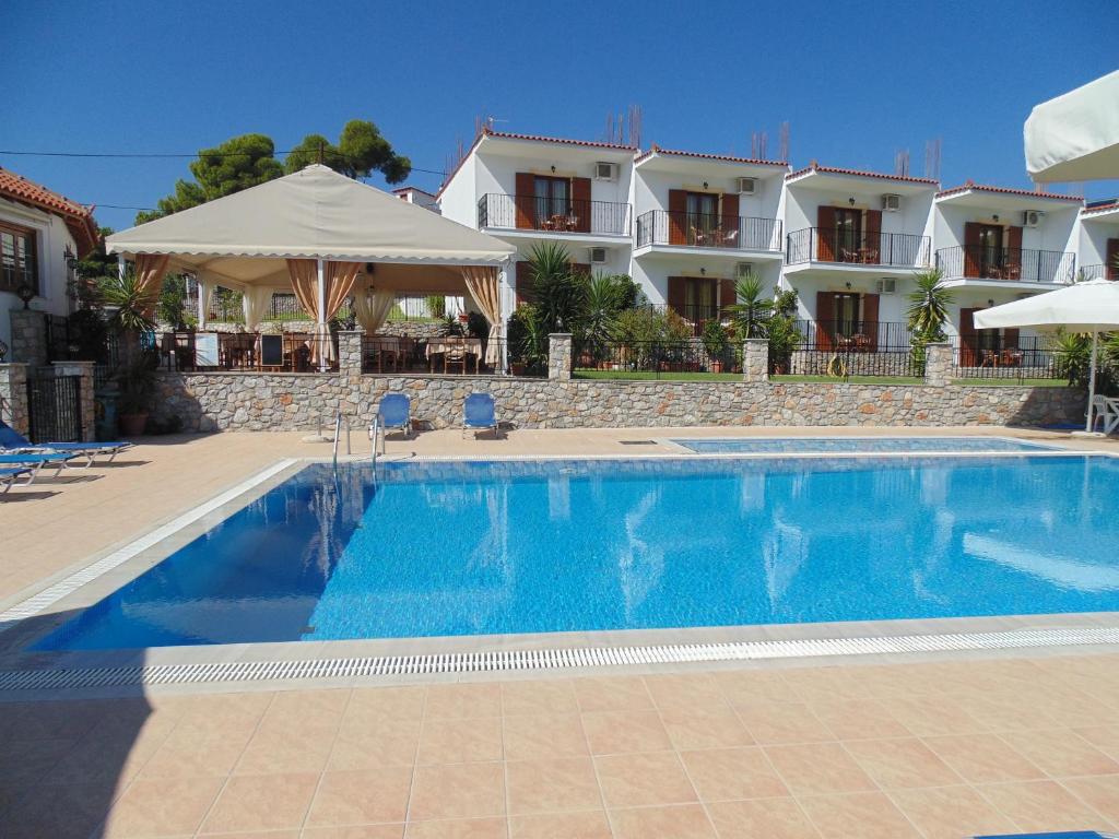 a large swimming pool in front of a house at Skiathos Diamond in Kolios