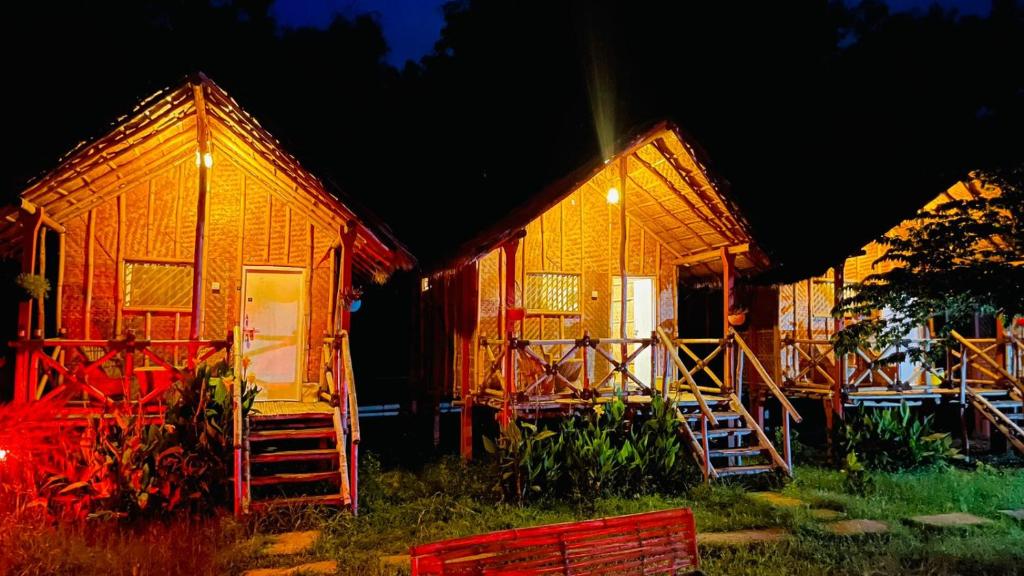 un par de casas con las puertas abiertas por la noche en HAPPY PLACE HAMPI en Hampi