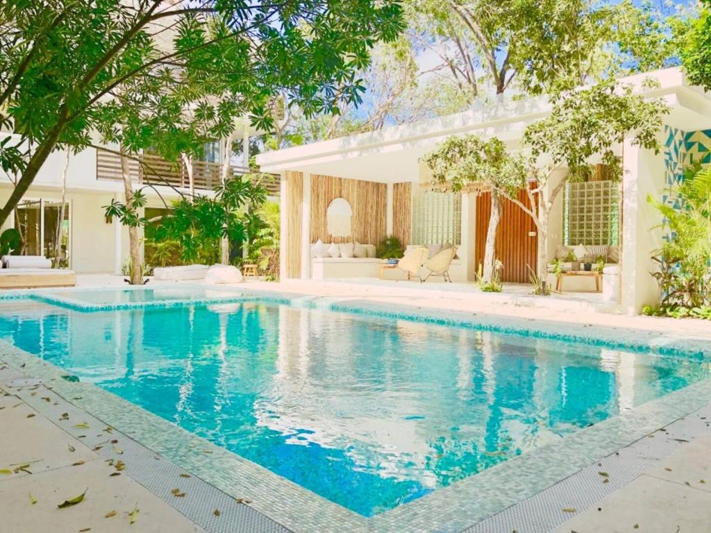 a swimming pool in the backyard of a house at ☆ Location & Comfort ☆ Jacuzzi ☆ Luxury Condo in Tulum