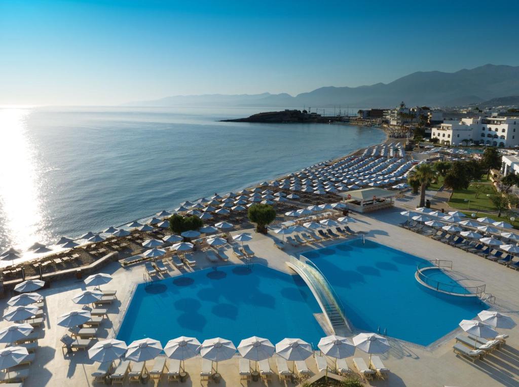 an aerial view of a resort with umbrellas and the ocean at Creta Maris Resort in Hersonissos