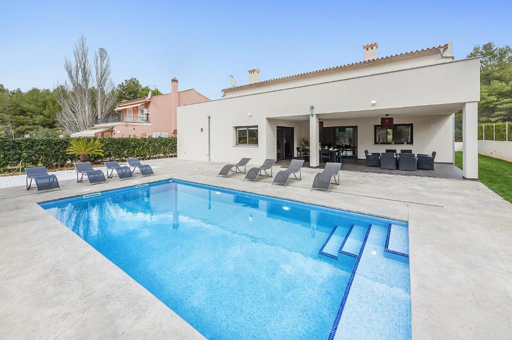 a swimming pool in the backyard of a house at Villa Lali in Alcudia