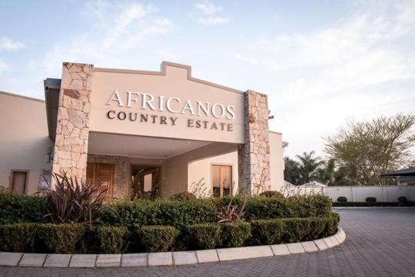 a building with a sign that reads athens county estate at Africanos Country Estate in Addo