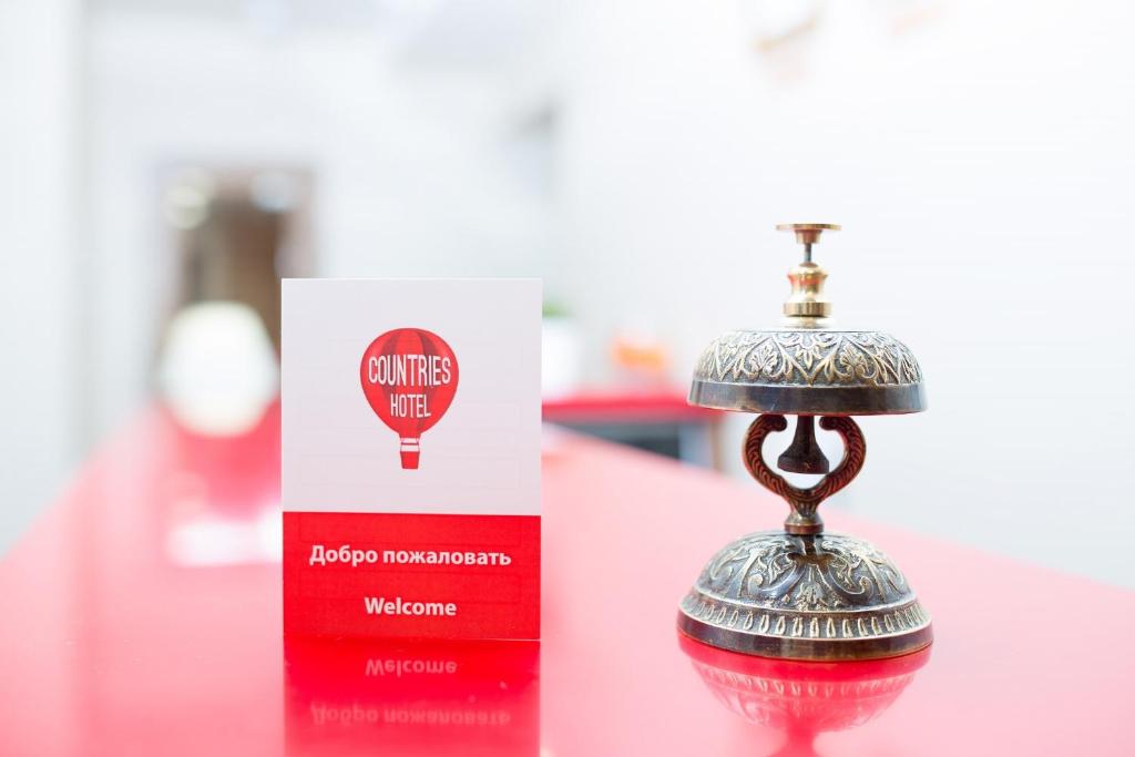 a red and silver ornament next to a box at Boutique Hotel Countries in Samara