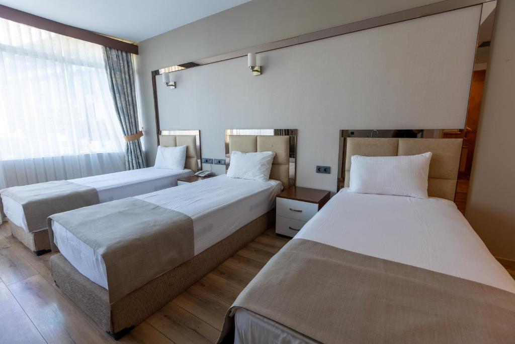 Postel nebo postele na pokoji v ubytování Asia Business Suites
