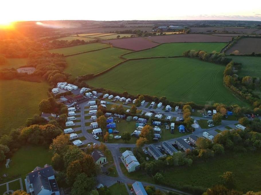 an aerial view of a parking lot with tents at Polladras Holiday Park in Helston