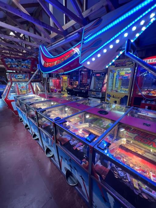 a row of games in a arcade with lights at Polladras Holiday Park in Helston