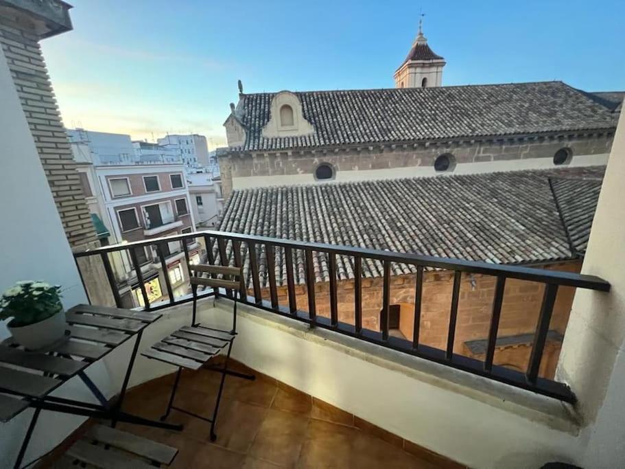 a balcony with a railing and a chair on a building at Apartamento céntrico San Miguel in Córdoba