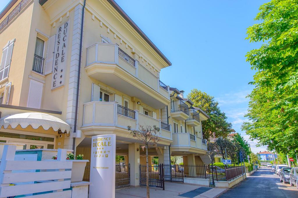 a large building on the side of a street at Residence Ducale in Rimini
