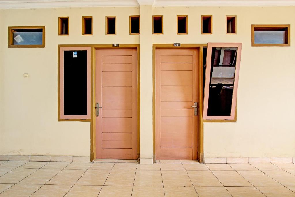 two doors on the side of a building at OYO Life 92663 Karmel 6 in Purwokerto