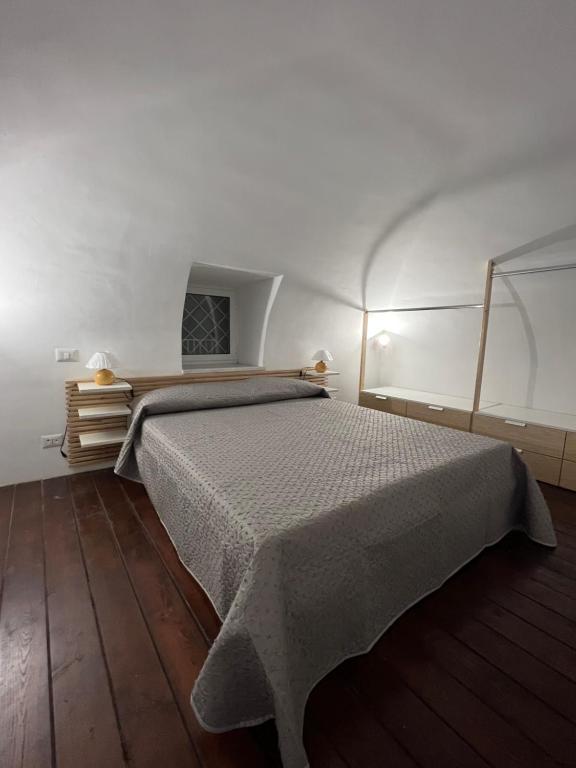 um quarto com uma cama num quarto branco em P.house2023 em Torre del Greco