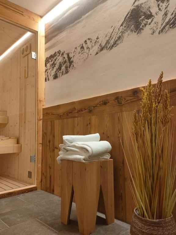 a pile of towels sitting on a stool in a sauna at Fior di Roccia Apartments- in centro Cervinia, sauna privata, Matterhorn dream in Breuil-Cervinia