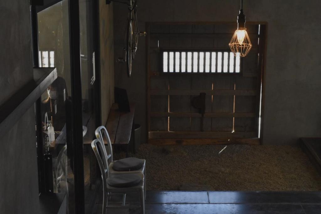 a living room with two chairs and a chandelier at kagelow Mt.Fuji Hostel Kawaguchiko in Fujikawaguchiko