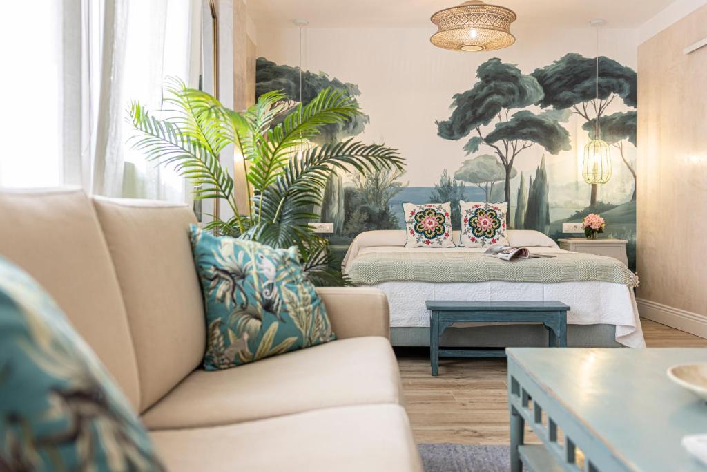 a living room with a couch and a bed at Cathedral Keepers - Exclusive apartment in Jerez in Jerez de la Frontera