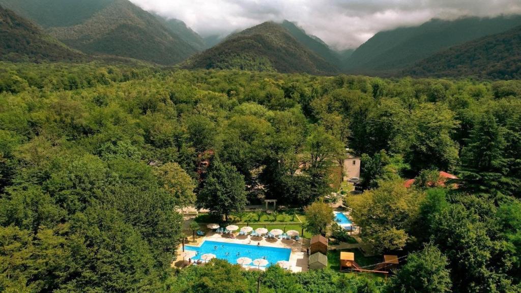an aerial view of a resort with a swimming pool and mountains at Wald Hotel Lagodekhi Rooms in Lagodekhi
