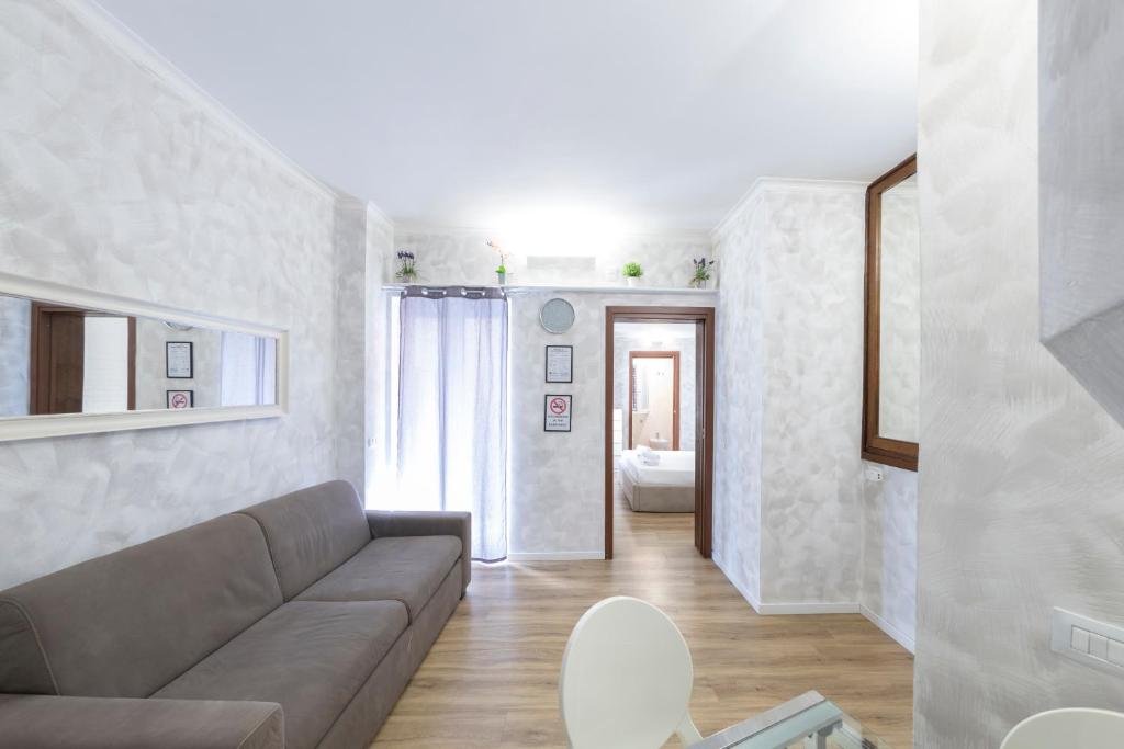 a living room with a couch and a room with a bedroom at Home Holiday Rome - 2° Floor in Rome