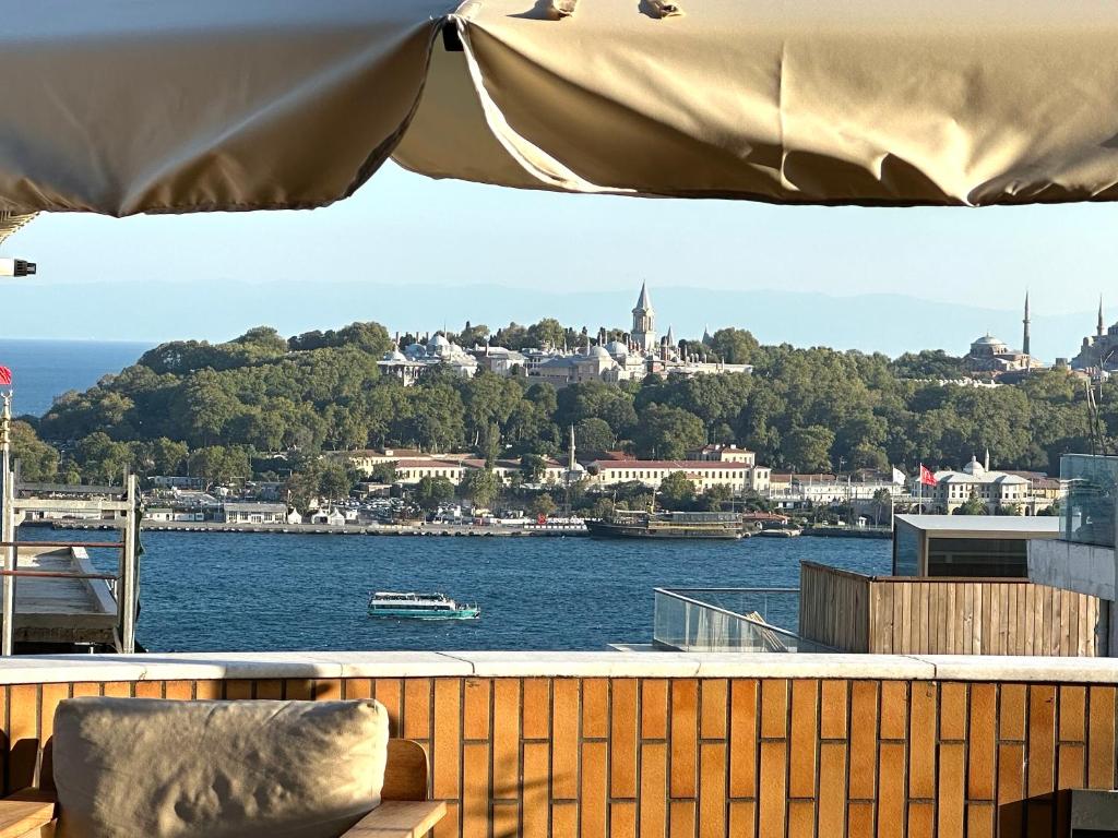 a balcony with a view of the water and a city at HOFT Cihangir in Istanbul