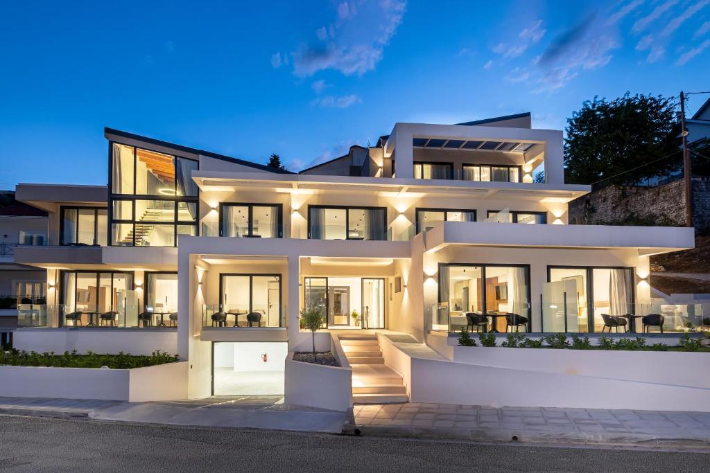 a large white house at night with lights at CITY HILL Luxury Apartments in Ioannina