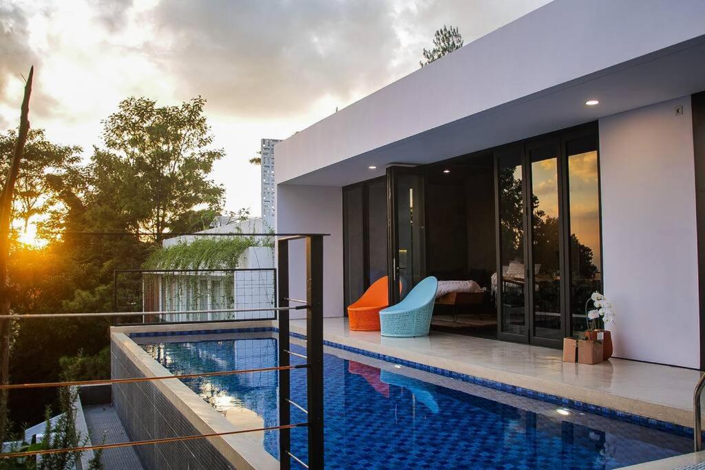 une maison avec une piscine sur un balcon dans l'établissement MALLO VILLA - DAGO VILLAGE - NEW VILLA & FURNISH, à Bandung