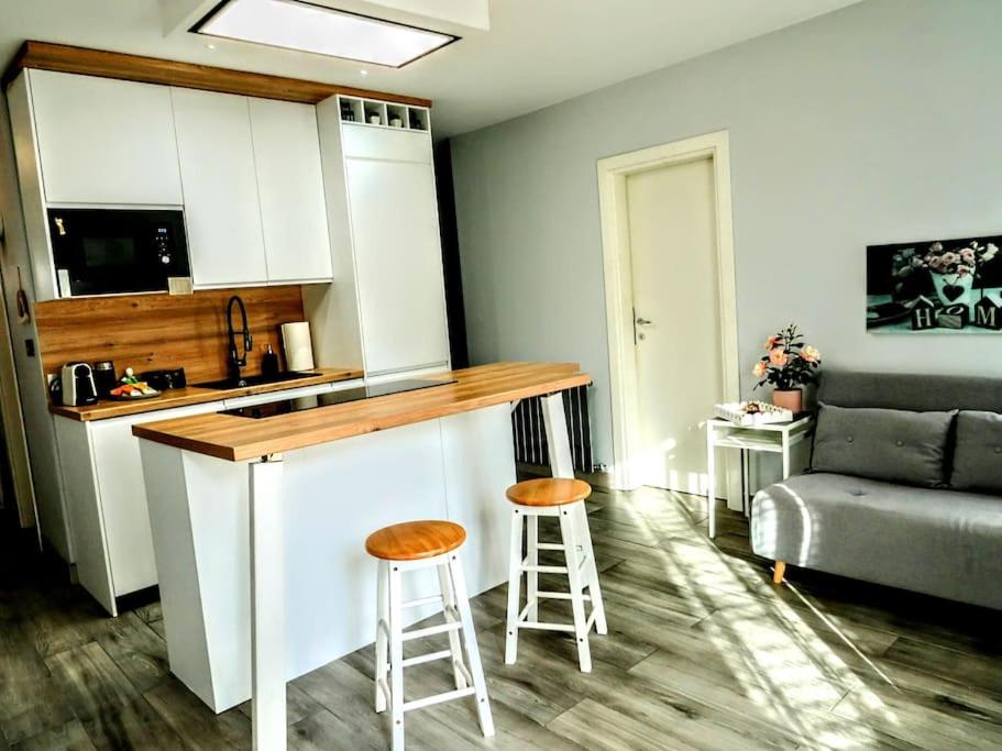 uma cozinha com um balcão e bancos num quarto em Madison - Cozy one-bedroom flat em Eltham